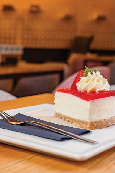 Slice of cheesecake with a strawberry on top